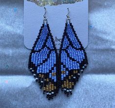 a pair of blue and yellow beaded earrings