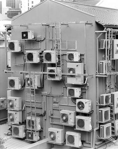 many air conditioners are stacked on top of each other in this black and white photo