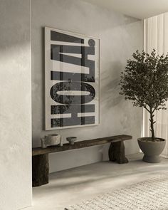 a white room with a tree and two vases on the table next to it