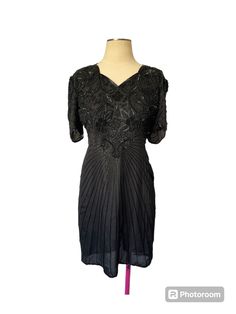 This vintage Scala dress is a stunning little black dress from the 80s or 90s. The beaded design adds a touch of glamour to any occasion, making it perfect for a night out or a special event. The dress is made with high-quality materials and has been well-maintained over the years, ensuring its timeless beauty. The brand name is prominently displayed, adding to its appeal and authenticity. Whether you're a fan of vintage fashion or simply looking for a unique dress, this Scala little black dress is sure to impress. Vintage V-neck Party Dress, Fitted V-neck Vintage Party Dress, Elegant Vintage Evening Dress For Summer, Elegant Vintage Summer Evening Dress, Vintage V-neck Evening Dress For Summer, Elegant Vintage V-neck Dress For Party, Elegant Vintage V-neck Party Dress, Elegant Black Vintage Dress For Summer, Elegant Fitted Vintage Party Dress