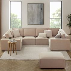 a living room filled with furniture next to two windows and a painting on the wall