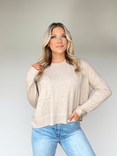 Feel comfortable yet stylish with the Mellow Mood Top. Featuring a rounded neckline, pocket detail, and relaxed fit, this crop top is essential for lounging, layering and brunch shopping. Crafted with the utmost comfort and luxury, the soft and stretchy fabric pairs well with any ensemble, making it a winter wardrobe staple. Enjoy versatile and effortless comfort and style with the Mellow Mood Top. Self 80% Polyester 14% Rayon 6% Spandex Machine wash cold. Casual Fall Tops With Cropped Hem, Spring Everyday Cropped Hem Tops, Relaxed Soft Texture Top For Spring, Chic Everyday Crew Neck Crop Top, Casual Long Sleeve Soft Knit Crop Top, Casual Tops With Side Pockets For Everyday, Everyday Comfy Tops With Soft Texture, Comfy Solid Color Tops With Pockets, Comfy Everyday Tops With Soft Texture