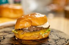 a hamburger sitting on top of a wooden table