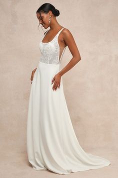 Everything will feel instantly perfect the moment you step into the Lulus Positively Romantic White Sheer Mesh Embroidered Maxi Dress on your big day! Intricate embroidery and shiny clear sequins adorn sheer mesh fabric as it shapes a seamed bodice with padded, lined cups, a scoop neckline, a low-cut back, and slender tank straps. The high, fitted waist tops a crepe knit A-line skirt that cascades down to a sweeping maxi hem with a lovely train at the back. Hidden back zipper/clasp. Fit: This ga Wedding Dress With Sheer Back And Sweetheart Neckline, Lace Backless Dress With Sheer Back, Lace Dress With Sheer Back And Backless Design, Embroidered Sweetheart Neckline Wedding Dress, Embroidered Wedding Dress With Sweetheart Neckline, Lace Embellished Bridesmaid Dress, Backless Embellished Wedding Dress, Sleeveless Wedding Dress With Lace Back For Wedding Night, Wedding Dresses With Sequins And Sweetheart Neckline