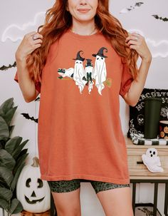 Get ready to embrace the spookiest time of the year with our exclusive Halloween shirt! This cozy and stylish tshirt features a vibrant design of classic Halloween elements including haunted houses, eerie pumpkins, flying bats, and ghostly figures. Made from a soft cotton blend, it ensures maximum comfort and warmth, perfect for chilly October nights. Whether you're heading to a Halloween party, trick-or-treating, or just looking to add some festive flair to your wardrobe, this shirt is the ideal choice. Available in a range of sizes, it's the perfect fit for everyone who loves the spooky season. Celebrate Halloween in style and comfort with our Spooky Halloween shirt! Fall Goblincore Crew Neck T-shirt, Goblincore Crew Neck T-shirt For Fall, Fall Goblincore Short Sleeve Tops, Halloween Goblincore T-shirt With Graphic Print, Halloween Goblincore Crew Neck Top, Halloween Goblincore Graphic T-shirt, Goblincore Halloween T-shirt With Short Sleeves, Goblincore Halloween Short Sleeve T-shirt, Spooky Cotton Top For Costume Party