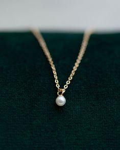 This Mini Pearl Pendant Necklace is the perfect complement for your evening wear or casual wardrobe. Crafted from 14k gold, this delicate necklace features a small cultured pearl, lending it a minimalist and elegant look. With this classic and versatile accessory, you're sure to make a statement. Pearl size: 2.75-3mm 14k Yellow Gold Classic Pearl Necklace With Delicate Chain, Dainty Pearl Chain Necklace For Formal Occasions, Minimalist 14k Gold Necklace With Pearl Pendant, Delicate Everyday Pearl Necklace In 14k Gold, Delicate Everyday 14k Gold Pearl Necklace, Dainty 14k Gold Pearl Necklace, Minimalist 14k Gold Pearl Necklace With Pearl Charm, Minimalist 14k Gold Pearl Necklace Gift, Minimalist 14k Gold Necklace With Pearl Charm