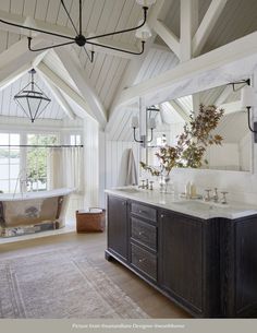 a large bathroom with two sinks and a bathtub in the middle of the room