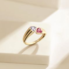 Unveiling the 'Hearts As One' Toi Et Moi Promise Ring, a masterful expression of love's enduring bond. This ring captures the essence of companionship with two heart-shaped stones, a clear white and a soft pink, set intimately side by side. Their luminous colors shine against the polished band, a symbol of enduring partnership and shared dreams. Celebrating 'Toi Et Moi,' French for 'you and me,' it reflects a perfect union of unique individuals coming together in harmony. This piece isn't merely Valentine's Day Proposal Heart Ring With Vs Clarity, Heart-shaped Promise Ring, Promise Crystal Open Ring With Birthstone, Valentine's Day Fine Jewelry Crystal Ring, Heart-shaped Birthstone Ring For Mother's Day, Heart-shaped Gemstone Rings For Mother's Day, White Couple Rings For Valentine's Day Anniversary, Heart Shaped Gemstone Rings For Mother's Day, White Heart Ring With Vvs Clarity For Anniversary