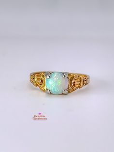 Item Description: This exquisite opal ring is a true gem from the Antique Edwardian/Art Deco period. Crafted in 14K yellow gold with intricate carved detailing on the band, this ring showcases a stunning pale blue opal with captivating red undertones when exposed to light. The single stone opal is cut in a cabochon style, measuring approximately 7mm in width, 7mm in length, and 4mm in depth. The band width is a delicate 1mm at its shortest. Don't miss the opportunity to own a piece of history with this timeless and elegant opal ring. Key Information: - Category: Fine Jewelry - Era: Antique Edwardian/Art Deco Period - Metal: 14K Yellow Gold with White Gold Prongs - Stone: Opal - Stone Shape: Cabochon - Stone Color: Pale Blue with Red Undertones - Size: Approximately 6.5 - Measurements: 7mm Fine Jewelry Gold Opal Birthstone Ring, Heirloom Yellow Gold Moonstone Cabochon Ring, Classic Yellow Gold Opal Ring, Gold Opal Ring With Birthstone, Heirloom Gold Opal Gemstone Ring, Gold Opal Birthstone Ring, Gold Ethiopian Opal Heirloom Rings, Heirloom Ethiopian Opal Gold Rings, Classic Opal Moonstone Anniversary Ring