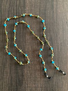 a long beaded necklace with turquoise beads