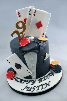 a birthday cake decorated with playing cards and casino chips