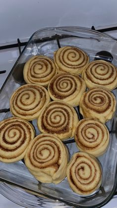 several cinnamon rolls in a glass baking dish