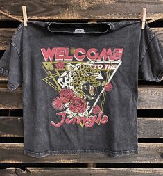 Country Deep Welcome to the Jungle Vintage relaxed fit cotton T-Shirt. available in Acid mineral wash black This relaxed fit Crew neck T-shirt is wider than a normal Tee for a more relax flowy fit. It's mineral washed to look and feel just like your favorite vintage T shirt .Hemmed at the bottom Made from 100% ringspun cotton, the fabric is substantial but washed down and exceptionally soft. Broken in for a lifetime of comfort and wear in vintage black SIZING Small-Width 20 inches --Length botto Welcome To The Jungle Shirt, Acid Wash T Shirt, Welcome To The Jungle, Acid Wash, Vintage Tshirts, Cotton T Shirt, Vintage Black, Neck T Shirt, Cotton Tshirt