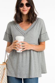 Waffle texture + a babydoll fit make this top a dream! It is easy and effortless, yet will have you looking so stylish. Raw edges and exposed seams add a cool, casual vibe, and the fabric is a soft and lightweight poly-rayon blend that offers plenty of stretch. *also offered in white* Spring Textured Tops For Loungewear, Textured Tops For Spring Loungewear, Spring Textured Loungewear Tops, Chic Waffle Knit V-neck Top, Soft Knit V-neck Top, Textured Casual Tops For Loungewear, Knit Textured Tops For Layering, Soft Knit V-neck Top For Loungewear, Casual Textured Tops For Layering