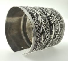 "Presenting a wonderful vintage, solid silver cuff BRACELET from Tunisia. The bracelet measures over 2 1/2\" (6,45 cm) wide and its inner diameter is 2 3/4\" (7,0 cm), though it is FULLY ADJUSTABLE. The bracelet features wonderfully textured floral and geometric designs. It has Tunisian and Libyan hallmarks for 800 silver. This piece is also an excellent size for a man's wrist." Ornate Handmade Ceremonial Cuff Bracelet, Ornate Handmade Antique Silver Cuff Bracelet, Unique Antique Silver Cuff Bracelet With Intricate Design, Collectible Cuff Bracelet Bangle With Intricate Design, Collectible Cuff Bracelet With Intricate Design, Collectible Cuff Bangle With Intricate Design, Handmade Antique Silver Cuff Bracelet For Ceremonial Occasions, Handmade Antique Silver Cuff Bracelet For Ceremonial, Traditional Cuff Bracelet With Intricate Design