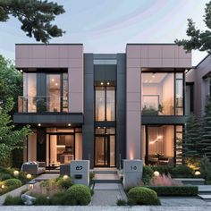 a modern house with lots of windows and landscaping