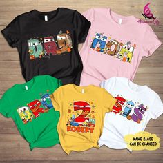 three t - shirts with cartoon characters on them