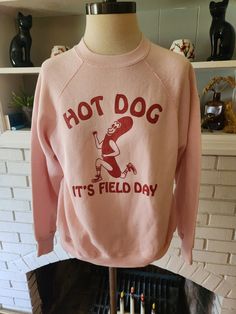 "Here is an awesome vintage sweatshirt by Tultex 50/50 polyester and cotton blend, and made in the USA. Light pink shirt with bold red graphic. About the design. This graphic was on a t-shirt from the 80s that I had for a while. I relished how goofily adorable it was. But to be frank, the shirt it was on was a child's small, which did me no good. I was able to catch up with my friend Jesse, and he worked his buns off to replicate the design for printing on adult sized shirts. This is the second Vintage Crew Neck T-shirt Relaxed Fit, Vintage Relaxed Fit Crew T-shirt, Vintage Cotton Crew T-shirt, Vintage Cotton Crew Neck T-shirt, Retro Crew Neck Sweatshirt With Text Print, Vintage Red T-shirt For Winter, Vintage Long Sleeve T-shirt With Text Print, Retro Crew Neck Pre-shrunk Top, Vintage College Sweatshirt With Text Print