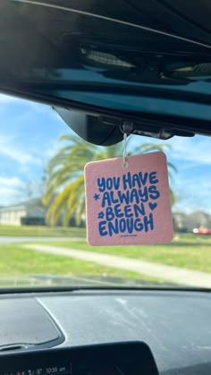 a pink sign hanging from the side of a car window that says, you have always been enough