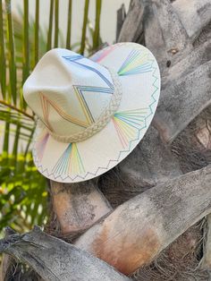 The wait is over! This hat is Ready to Ship and your order will be processed and shipped within 3-7 business days. Items with embroidery customization will be shipped within 2 weeks. White Palm Straw Hat with Pastel Fan Design. Custom designed and hand made hats by artisans in San Jose Del Cabo, Mexico. These hats are one size fits most with an elastic band inside to add comfort and fit for all head sizes. Please note, all hats come with natural braid unless custom braid is purchased. Multicolor Flat Brim Panama Hat, Multicolor Flat Brim Fedora, Custom Multicolor Wide Brim Hat, Custom Wide Brim Multicolor Hat, Custom Multicolor Brimmed Hat, Custom Multicolor Hat With Curved Brim, Custom Multicolor Flat Brim Hats, San Jose Del Cabo Mexico, Rainbow Hat