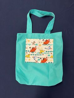 "One of each Tote Bag design is available, featuring various cartoon characters: Lion King, Daniel Tiger, Minnie and Mickey Mouse together on plaid, Bluey, Sonic and others. All totes 100% cotton, except Aqua which is Polyester.  Size: 13.5\" x 13.5\" x 4\" (4\"gusset) Washable in cool or cold water, hang dry or tumble dry low. Iron on low or medium setting.  Details: Minnie Mickey Plaid, 13.5\" x 13.5\" x 4\"  Red tote bag shown in photo. Also available in other colors: Ivory (cream) color tote Blue Cartoon Bag For Everyday Use, Cartoon Style Blue Bag For Everyday Use, Multicolor Character Print Travel Bag, Cartoon Style Multicolor Rectangular Bag, Green Disney Bags For Everyday Use, Green Disney Style Bags For Daily Use, Playful School Bag With Character Print, Playful Multicolor Bags With Character Print, Multicolor Cartoon Style Bag For Everyday Use