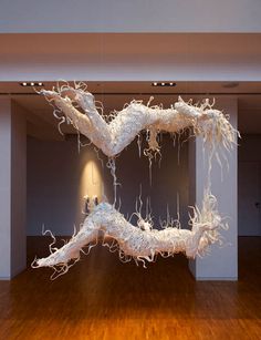 a large white sculpture sitting on top of a wooden floor