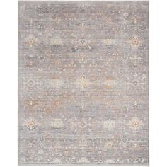 an area rug with various colors and patterns on the floor, including greys, browns,