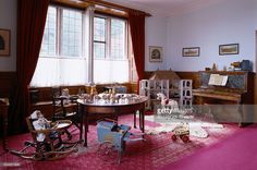 a living room filled with furniture and lots of windows