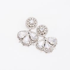 Our LEXES earrings are absolutely gorgeous and timeless to wear for a classic look. The silhouette consists of a a bigger floral design filled with crystals shaped in a leaf form to add a fine look. These will add a touch of sparkle to a stylish look. Handcrafted Highest Quality Swarovski / Cubic Zirconia Platinum plated Guards against scratches and tarnish. approximate size 1.15" length 1" width Nickel free Free Shipping in USA Glamorous Crystal Flower Earrings For Wedding, Elegant Flower Shaped Clip-on Earrings For Party, Dazzling Crystal Embellished Cubic Zirconia Earrings, Elegant Crystal Earrings In Flower Shape, Crystal Bridal Earrings With Diamond Accents, Elegant Crystal Flower-shaped Earrings, Elegant Diamond Flower Earrings With Sparkling Stones, Wedding Jewelry With Rhinestones In Flower Shape, Elegant Crystal Flower Earrings For Party