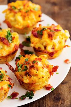 small breakfast muffins on a white plate with parsley sprinkled around them