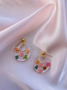 These cute resin earrings come with mini flowers and leaves. They have a gold ball stud.  Sizing: Circle is about 1 inch. Gold Round Flower Earrings For Spring, Trendy 3d Flower Earrings, Trendy 3d Flower Jewelry, Cute Gold Flower Earrings For Spring, Gold Floral Print Flower Earrings, Cute Gold Earrings For Spring, Trendy Round Flower Earrings As Gift, Trendy Round Flower Earrings For Gift, Gold Round Flower Earrings In Resin