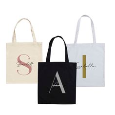 three tote bags, one with the letter a and two with the initial s