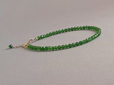 Such a delicious bracelet with vibrant green chome diopside rondelles  Please measure tightly your wrist's circumference, using a ribbon or something similar, and then measuring the ribbon with a ruler. When ordering, please select the actual wrist size, not the size of the bracelet. I will make the bracelet fit your wrist, by adding approx 0.6 inch to the circumference. The bracelet was set up using genuine chrome diopside faceted rondelles and sterling silver findings and it is adjustable. Diopside, also called ' The Analytical Stone' is an empowering stone that helps to stimulate learning and understanding, to help one become better connected to the earth, and to bring love to oneself as well as other. Said to hold all the mysteries of the Universe many find that the green Chrome Diopsi Faceted Green Beaded Bracelets As Gift, Faceted Green Beaded Bracelets For Gift, Gift Green Faceted Beaded Bracelets, Green Gemstone Rondelle Beaded Bracelets, Green Rondelle Bracelets With Faceted Beads, Green Faceted Bracelets For Gift, Elegant Green Bracelets With Faceted Beads, Elegant Green Bracelet With Faceted Beads, Elegant Green Faceted Bead Bracelet