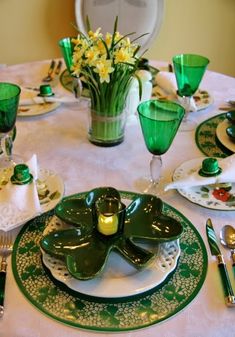 the table is set with green and white dishes