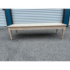 a bench sitting in front of a garage door