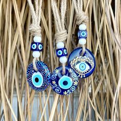 three evil eye glass beads hanging from a rope