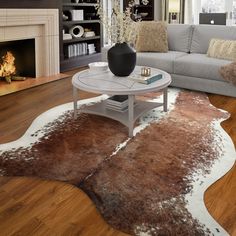 a living room filled with furniture and a fire place in the middle of the room