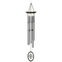 a wind chime hanging from the side of a white wall