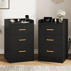 two black chests with gold handles in front of a white wall and rug on the floor