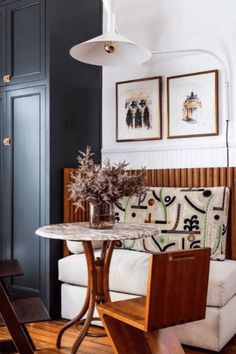 a living room filled with furniture and pictures on the wall