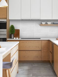 a kitchen with wooden cabinets and white counter tops