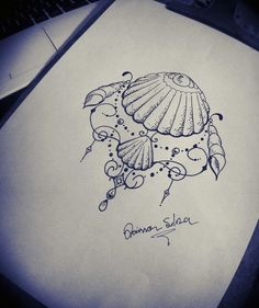 a drawing of a shell and an umbrella on top of a piece of white paper