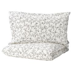 a white and black floral print pillow case with two pillows on the bottom one side