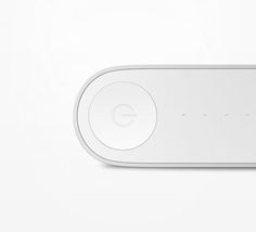 the google home button is shown on a white surface with an orange dot in the middle