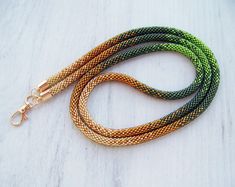 This Lanyard is made from Czech glass seed beads in shiny gold, brown, green and dark green. Very flexible and comfortable to wear. These lanyards not only make your everyday work outfit a little more stylish, but they are also functional accessories to hold your ID badge. They also make a perfect gift! Lanyard length : 38.5 inches (98 cm) Length with holder : 20 inches (50 cm) Keychain length including the ring: 8 inches (20 cm). To browse more of my bead crochet lanyards and keychains (ready t Adjustable Green Necklace For Everyday Use, Everyday Adjustable Green Necklace, Adjustable Green Lanyards As Gifts, Crochet Lanyards, Crochet Lanyard, Keychain Tutorial, Nurse Lanyard, Lanyard Teacher, Beaded Lanyard