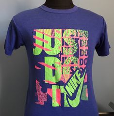 "Vintage 1980's-1990's blue Nike \"Just Do It\" t-shirt. Size: XL (fits more like ADULT MEDIUM) Brand: Nike 50% cotton, 50% polyester The shirt is very soft and in very good vintage condition, with no stains - though a small hole next to image on front and numerous small holes on back at bottom. Approximate measurements with garment laying flat (INCHES): Length (from top of shoulder at collar seam to bottom) : 27\" Sleeve (from top of shoulder seam to cuff edge) : 7\" Between Shoulder Seams : 17 It Shoes, Nike Vintage, Sports T Shirt, Athletic Sports, Blue Nike, Nike Just Do It, Vintage Sports, 90s Vintage, Vintage Nike