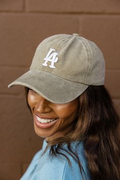 Introducing The LA Baseball Cap! This cute hat adds a touch of West Coast charm to any outfit. Coming in two washed colors, this cap is perfect for those laid-back days under the sun. metal buckle with hidden snap for easy on + off 100% cotton La Baseball Cap, Athleisure Mom, Clogs Heels, Invert Colors, Mom Accessories, Cute Hat, Back Day, Nursing Friendly, Boys Playing