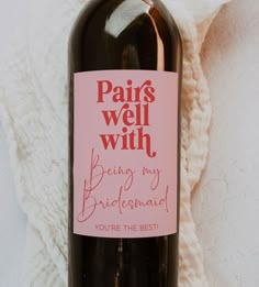 a bottle of wine with a pink label on it that says paris well with being my bridesmaid you're the best