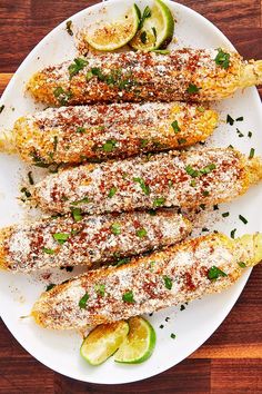 grilled corn on the cob topped with parmesan cheese and lime slices