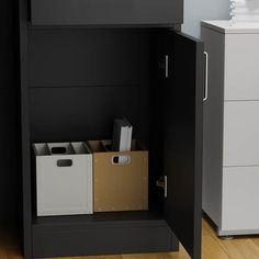 a black cabinet with some boxes and file folders in it next to a white dresser